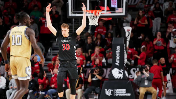 Cincinnati Bearcats forward Viktor Lakhin (30) encourages the crowd after a made 3-point basket in the second half during an NCAA college basketball game between Georgia Tech Yellow Jackets and the Cincinnati Bearcats, Wednesday, Nov. 22, 2023, at Fifth Third Arena in Cincinnati.